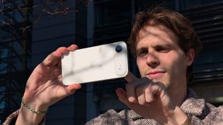 A man holding the iPhone Air in landscape