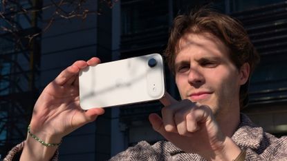 A man holding the iPhone Air in landscape