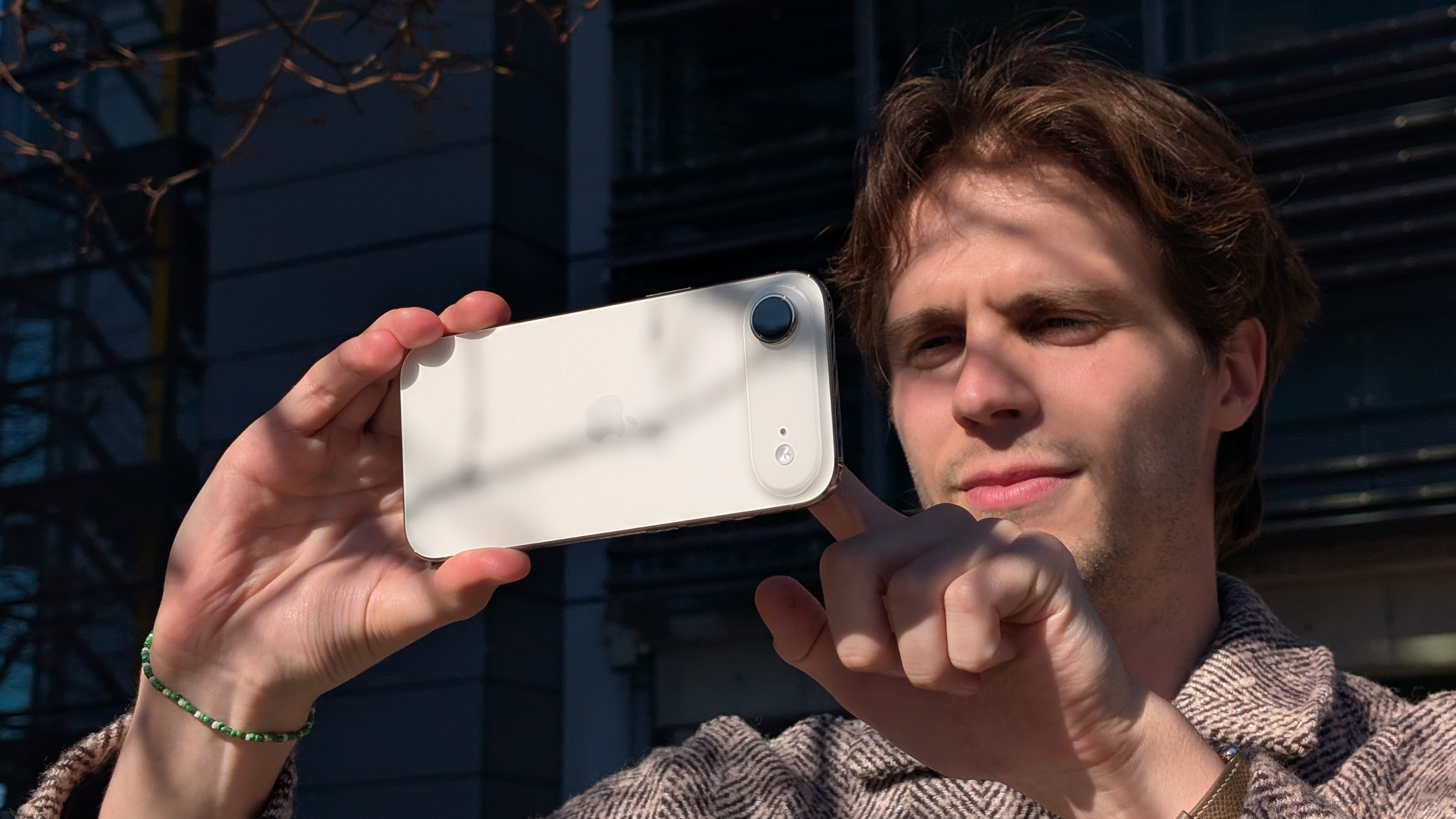 A man holding the iPhone Air in landscape