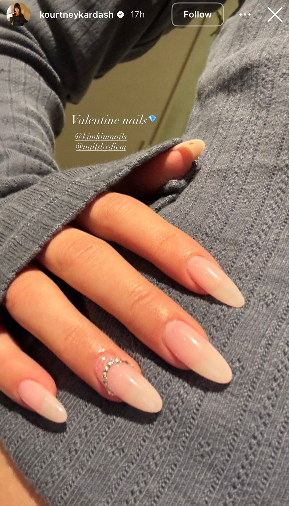 a person wearing a nude manicure with rhinestones