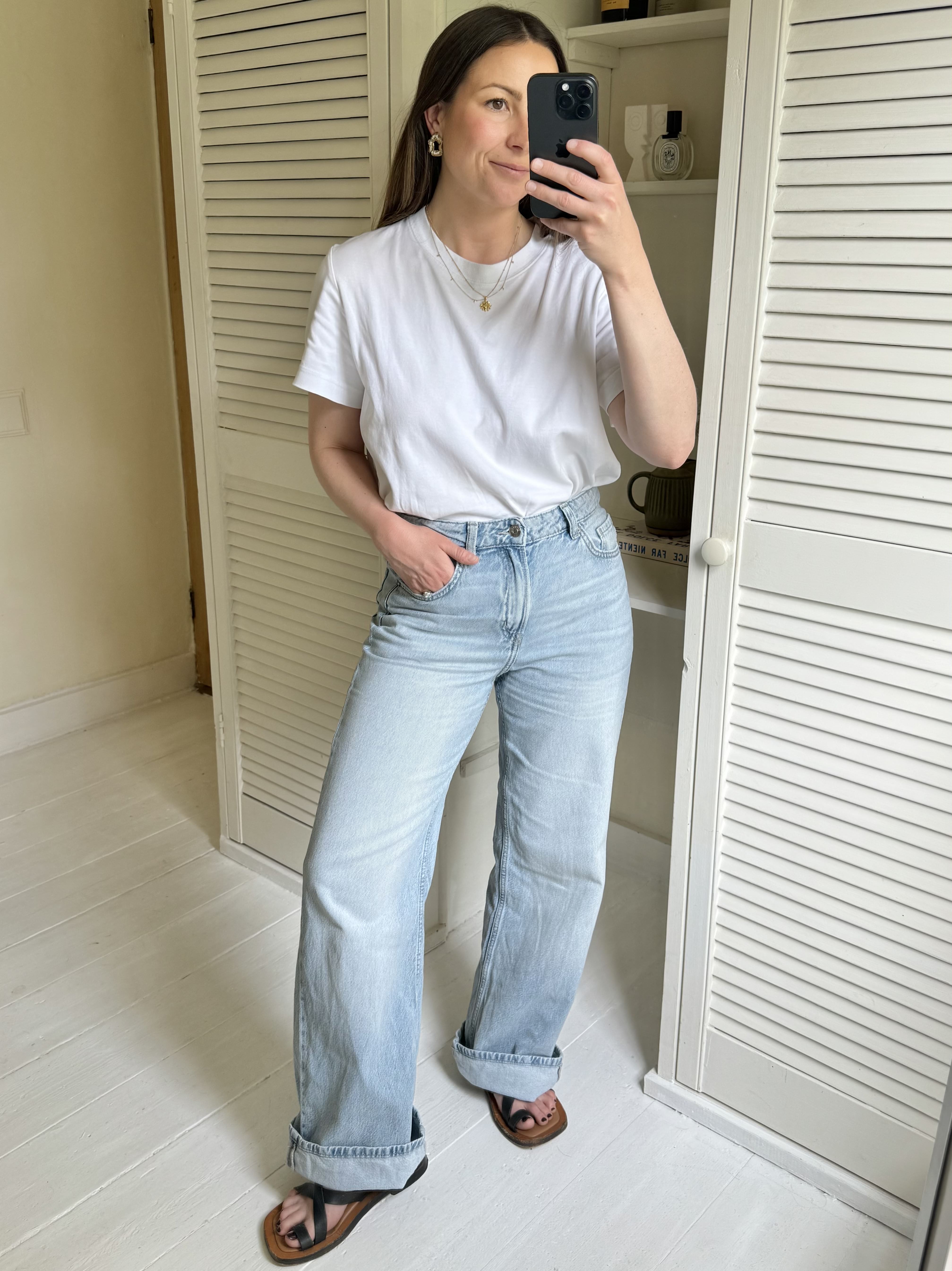 Woman tries on best-selling jeans: H&M wide high jeans.