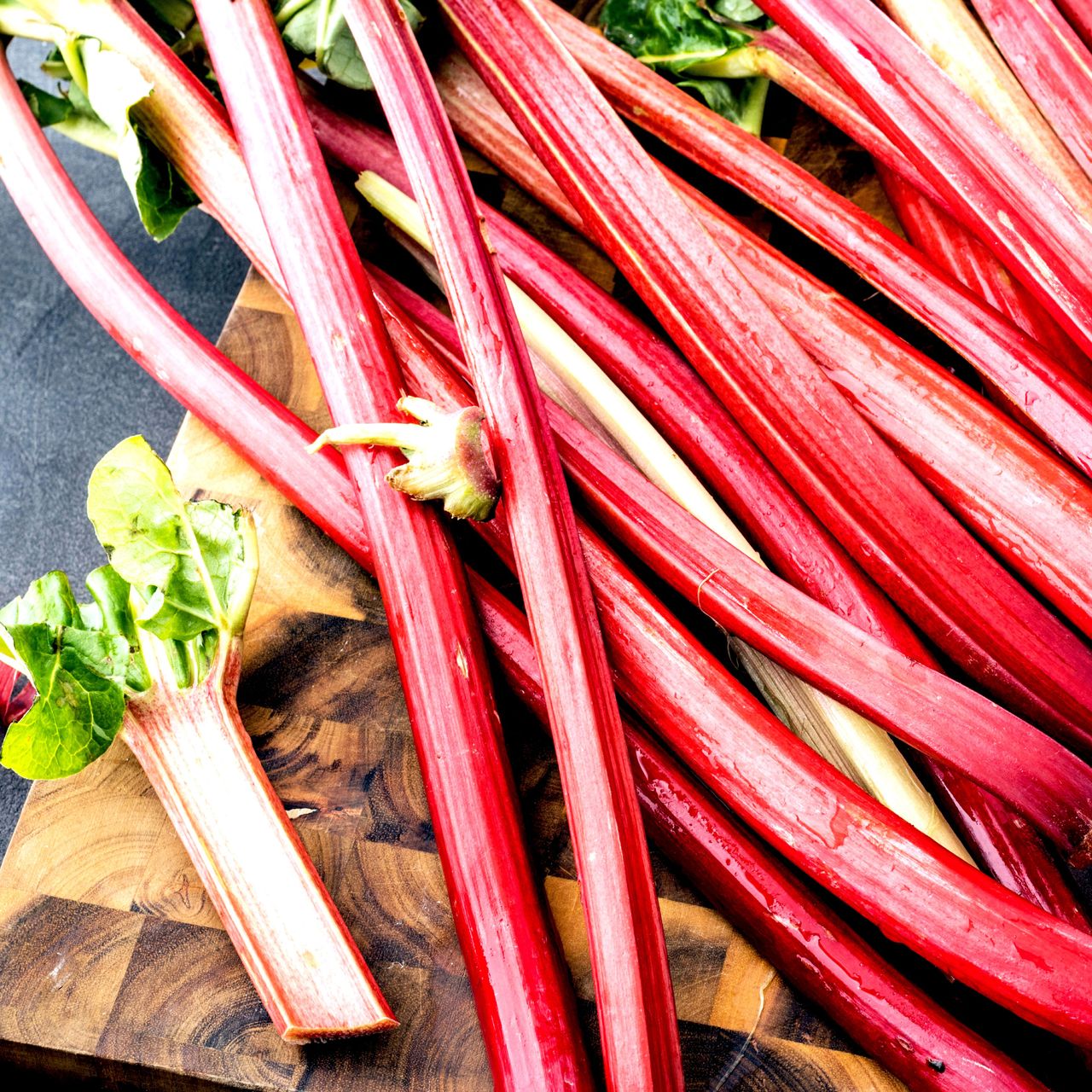 rhubarb stalks freshly harvested on chopping board