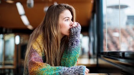 Teen girl looking out the window