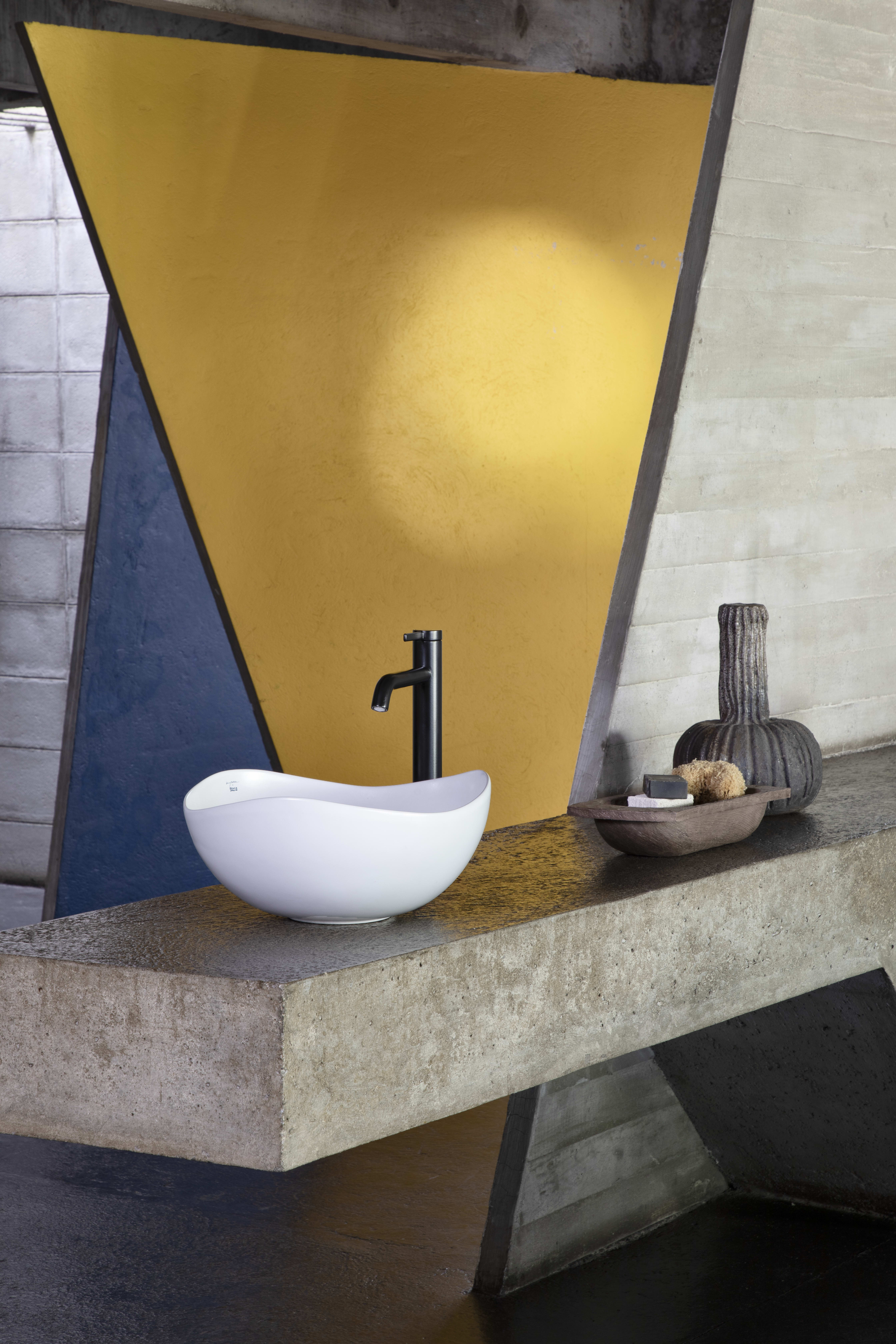white washbasin mounted on concrete worktop