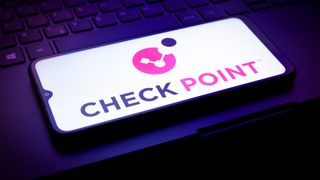 Check Point software logo and branding pictured on a smartphone placed on top of a laptop keyboard.