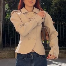 Kristina Ang in Paris wearing a fitted blazer and dark-wash jeans. 