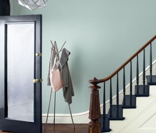 A staircase with walls painted in a light blue color