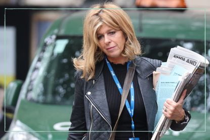 Kate Garraway wallking to work holding newspapers
