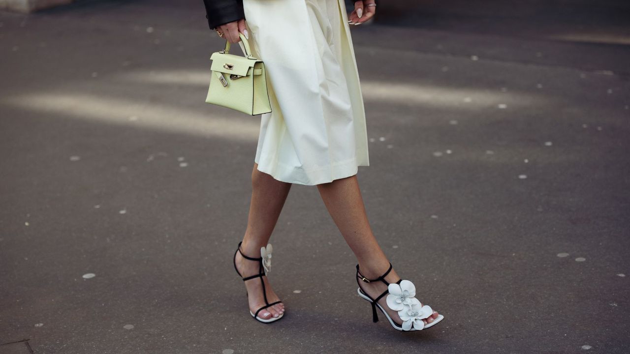 A woman wearing floral sandals and a spring pedicure