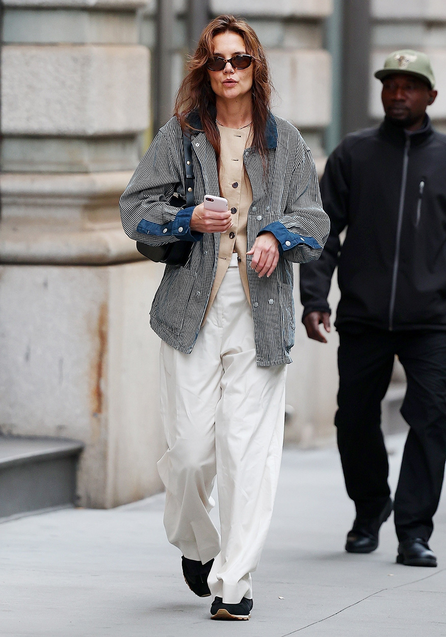 Katie Holmes wearing a jacket, vest, and white pants in NYC