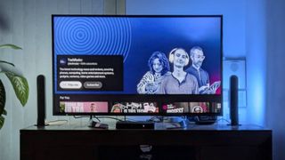 Mostly blue image shown on TV with Philips Hue Play Light Bars beside it