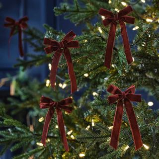 Red velvet bows on a christmas tree