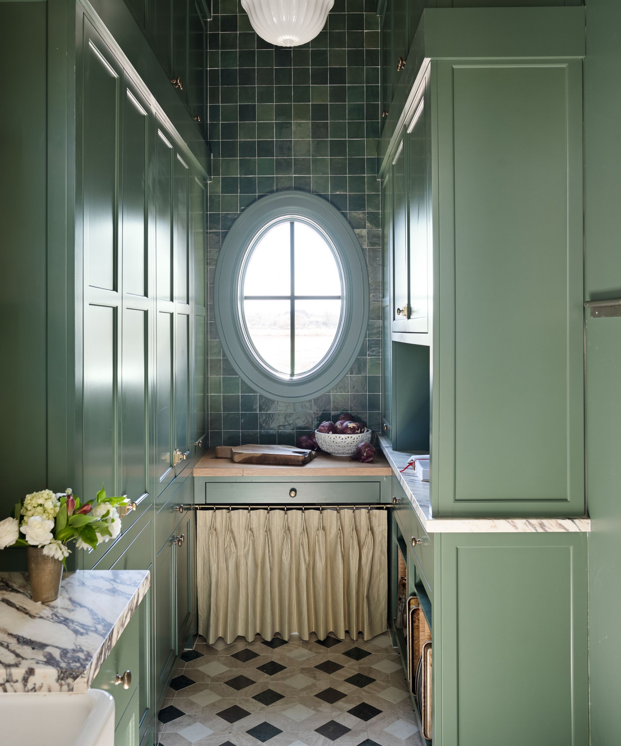 pale green kitchen cabinets with oval window