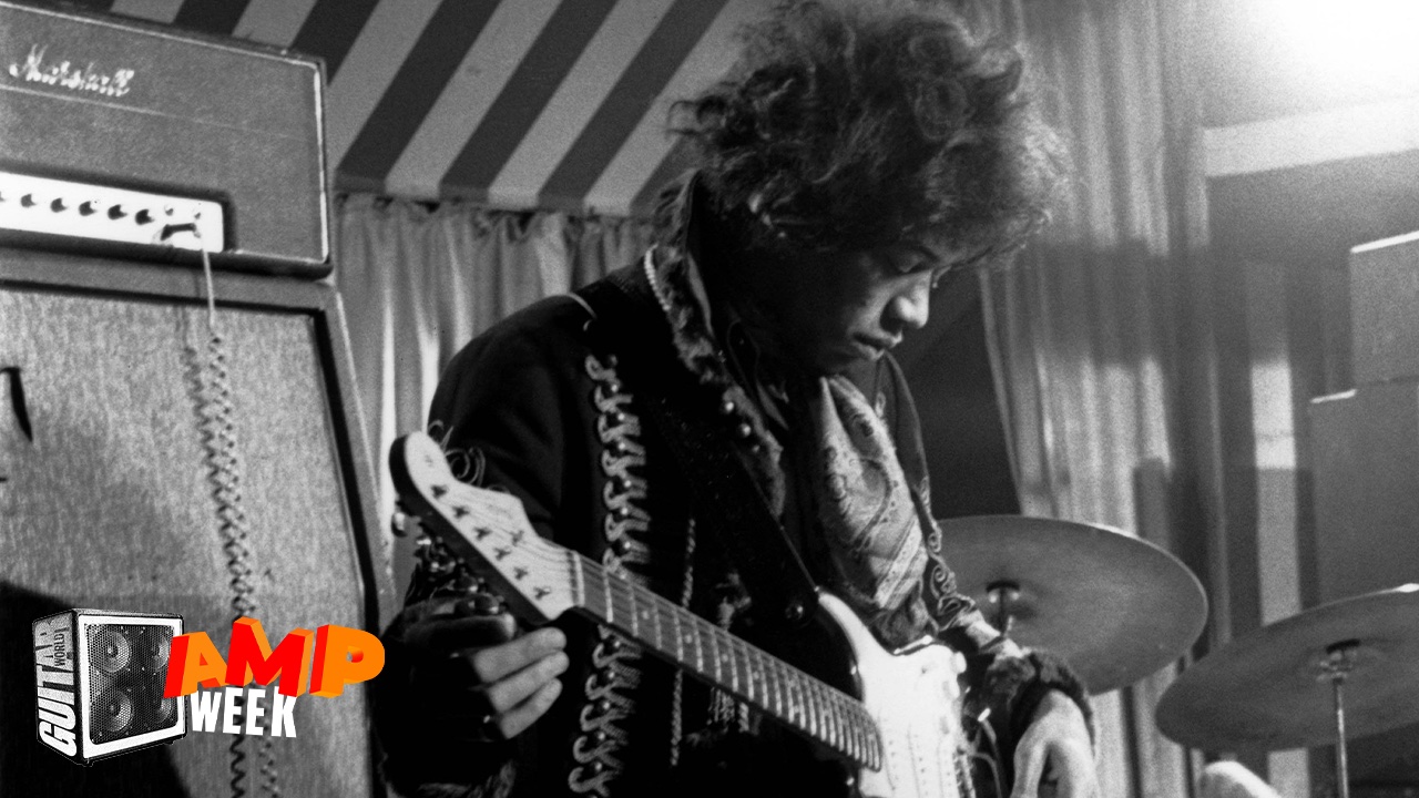 Jimi Hendrix performs onstage, his Marshall amplifier to his left