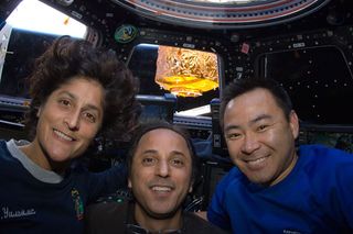 NASA astronauts Sunita Williams (left) and Joe Acaba (center), along with Japanese astronaut Aki Hoshide, float inside the International Space Station's cupola in August 2012.