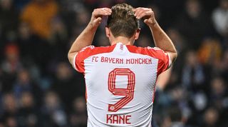 Harry Kane laments a missed chance in Bayern Munich's defeat at Bochum in February 2024.