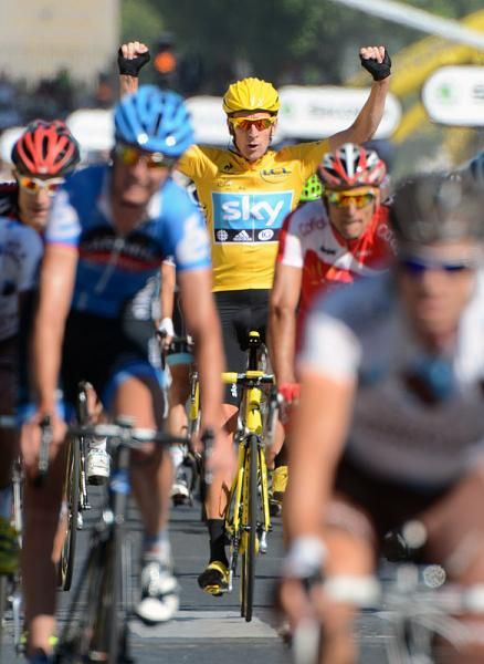 History in the making: Bradley Wiggins (Sky) crosses the finish line arms aloft as the first British Tour champion.
