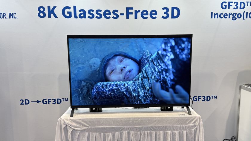 Visual Semiconductor's GF3D TV at CES 2026, showing a man pinned down under a monster's foot on the screen