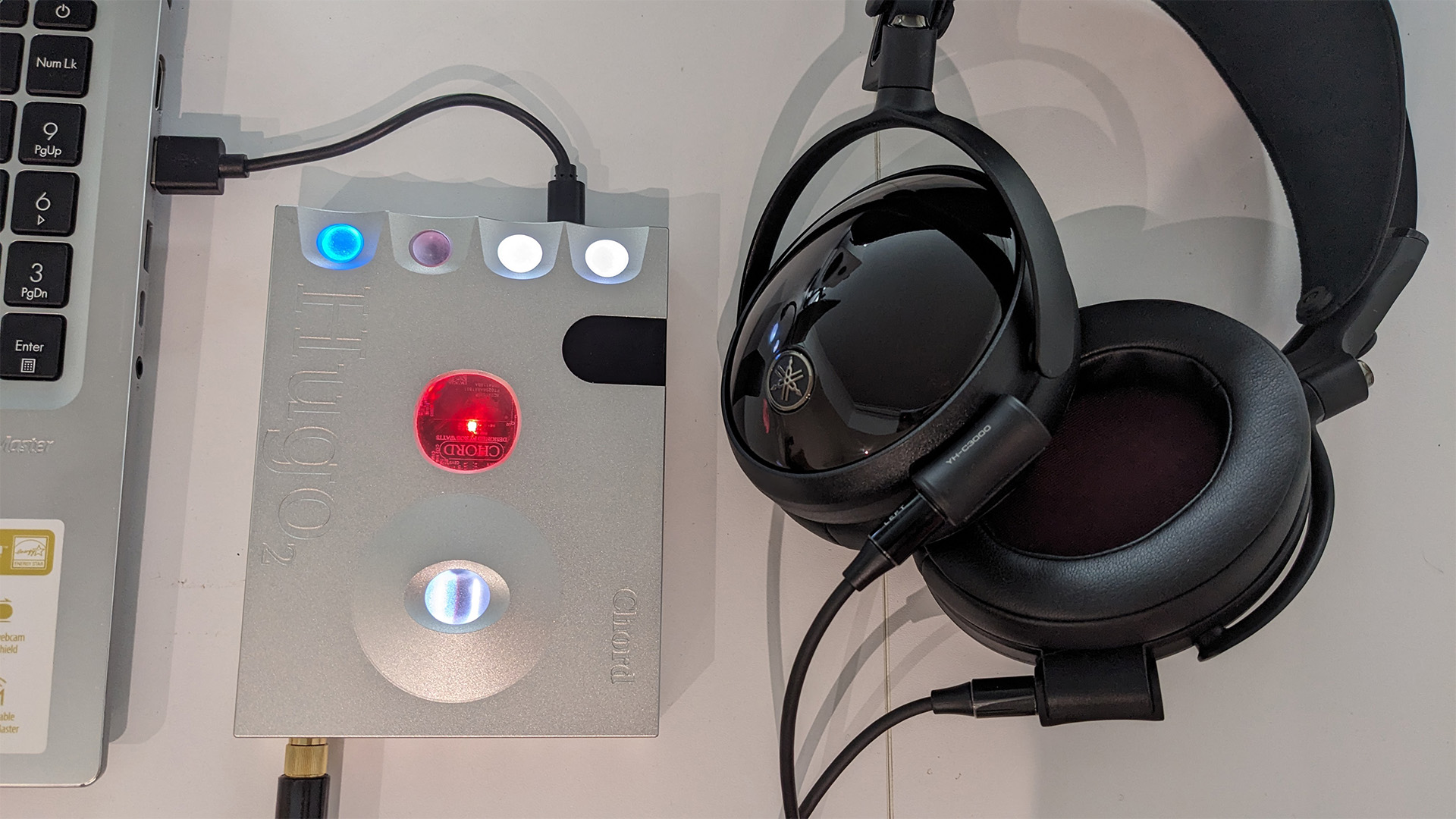 Yamaha YH-C3000 over-ear headphones next to Chord DAC and laptop