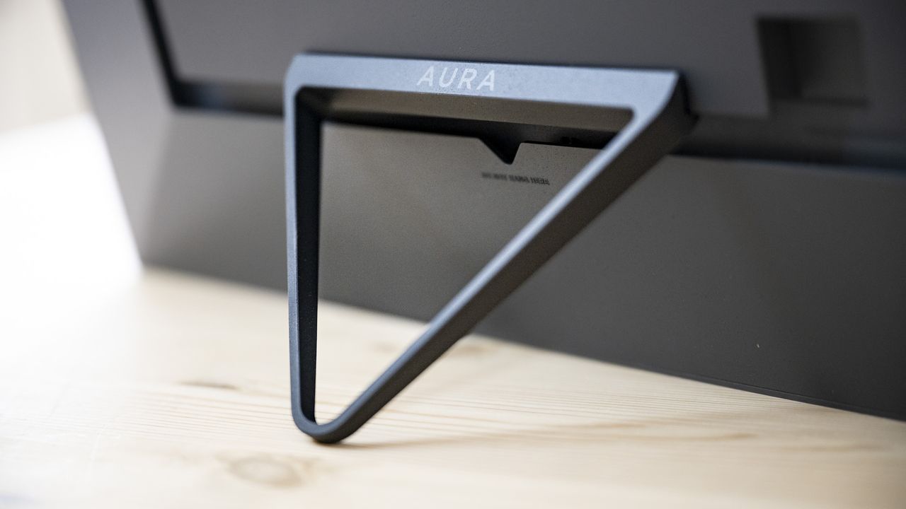 Supporting bracket of the Aura Walden digital photo frame on a wooden sideboard