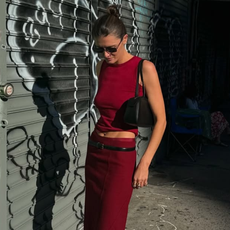 woman wearing matching red set with black boots in nyc summer outfit
