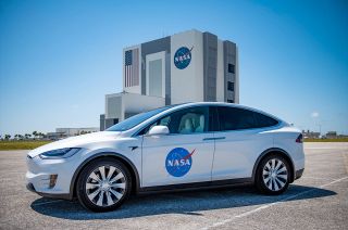 SpaceX's Tesla Model X astronaut transfer vehicle features NASA's red, white and blue insignia, dubbed the "meatball," on its front doors.