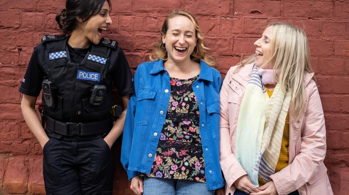 Rana (Taj Atwal), Toni (Leah Brotherhead), and Paula (Sinead Matthews) laugh together as the stars of Hullraisers season 2 on Channel 4