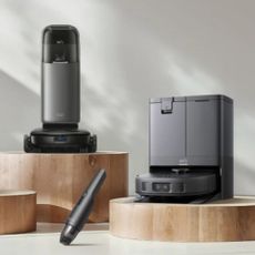 Eufy robot vacuums on pedestals with white background