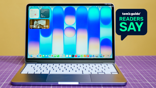 A photo of the MacBook Neo on a desk, with a 'Tom's Guide Readers Say' graphic overlaid
