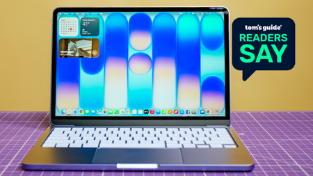 A photo of the MacBook Neo on a desk, with a 'Tom's Guide Readers Say' graphic overlaid