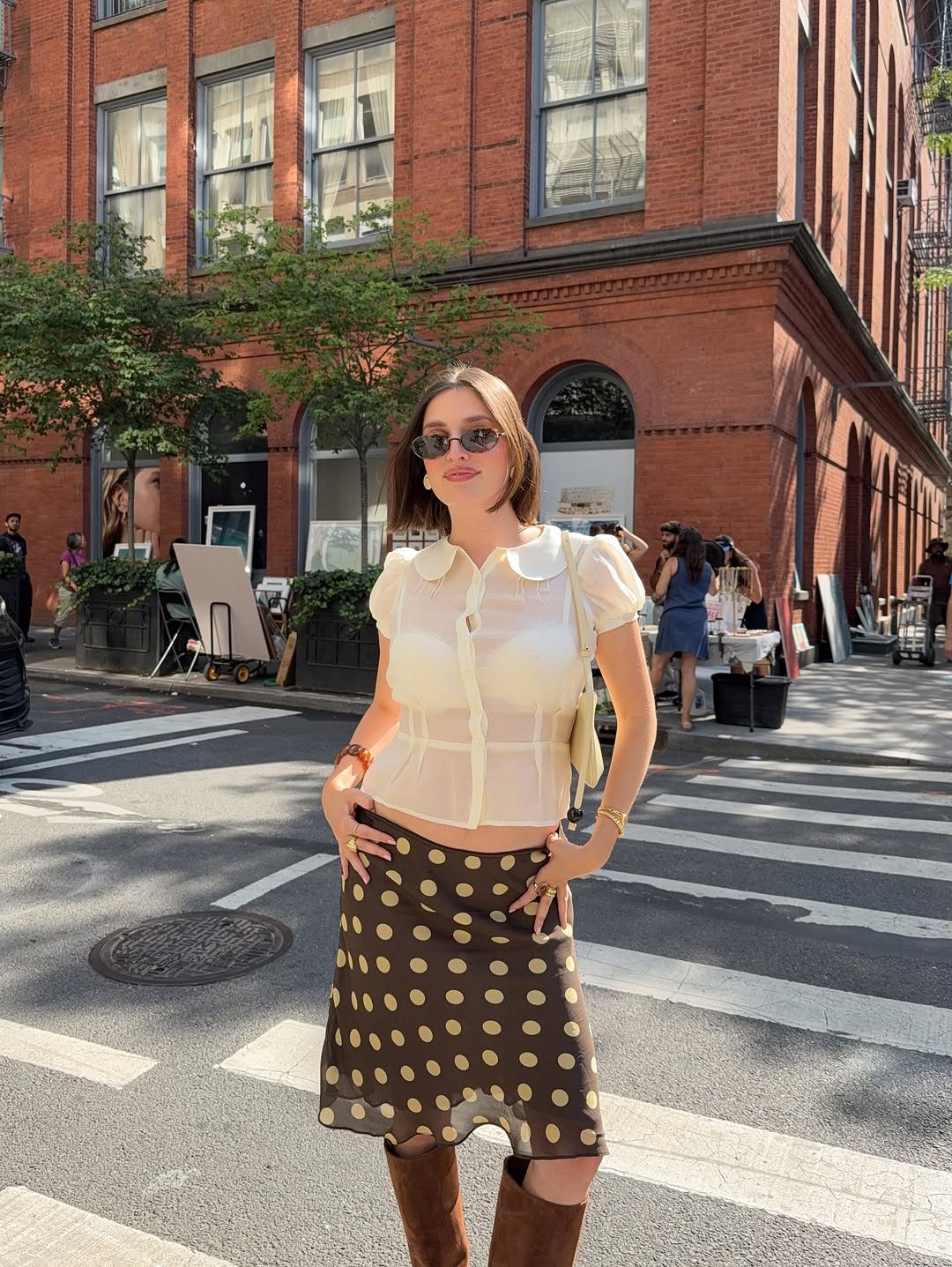 Woman wearing fall boots with skirt outfit 2025.