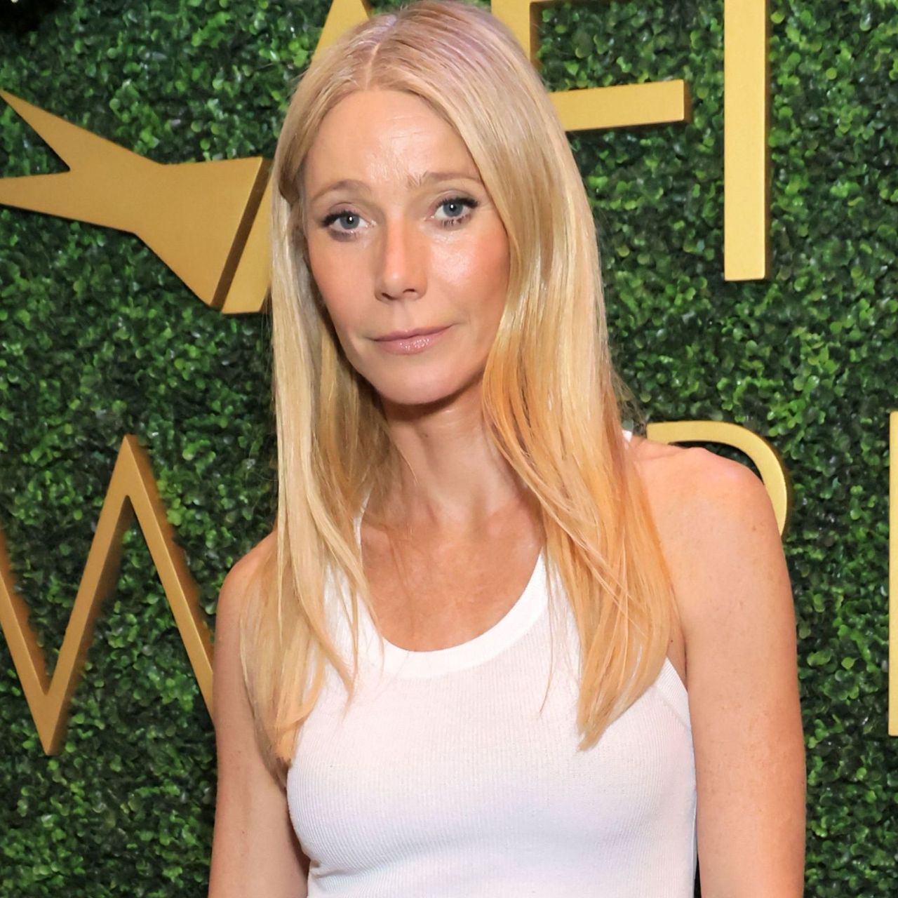 Gwyneth Paltrow Made a Basic White Tank Top Look Thoroughly Elegant With This Specific Skirt Trend