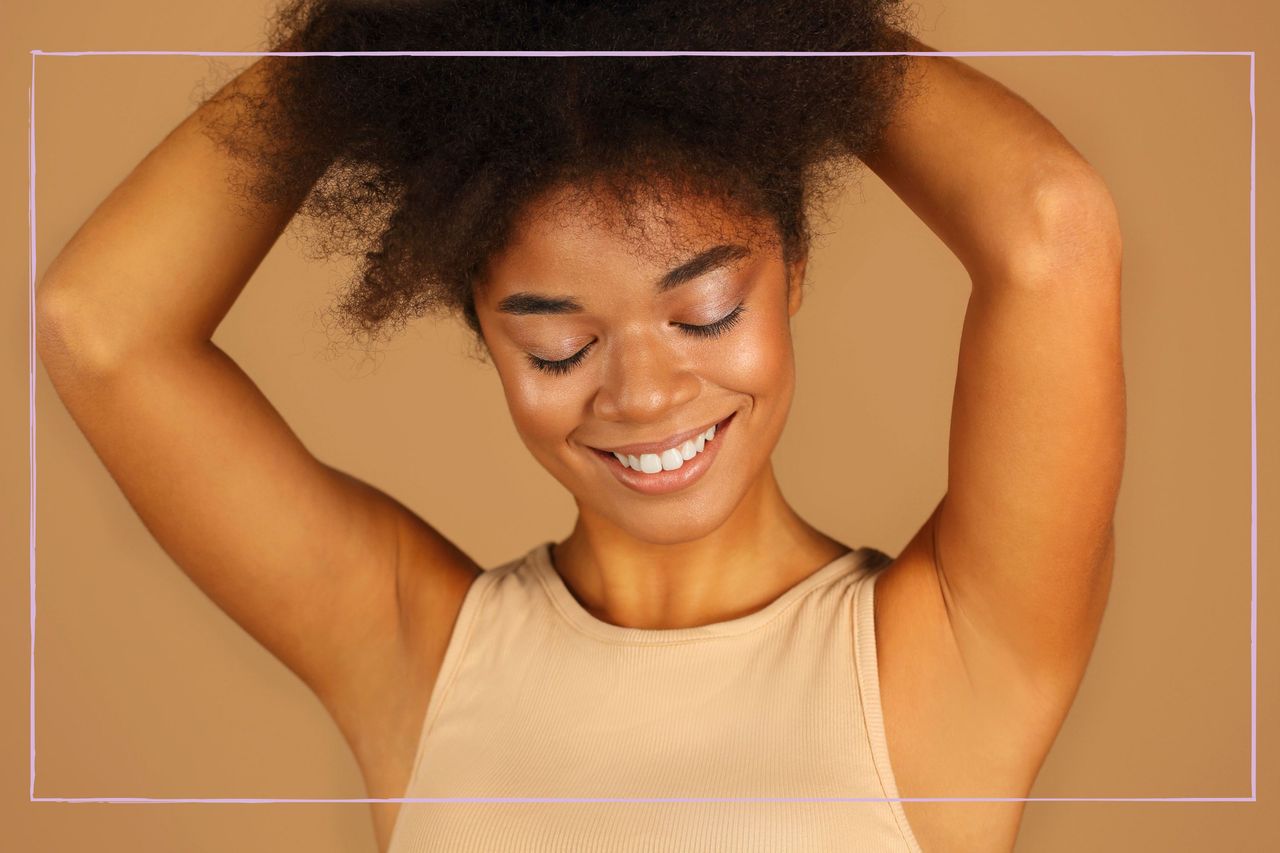 Teenage girl with arms raised showing her armpits