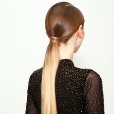 model with long sleek blonde ponytail