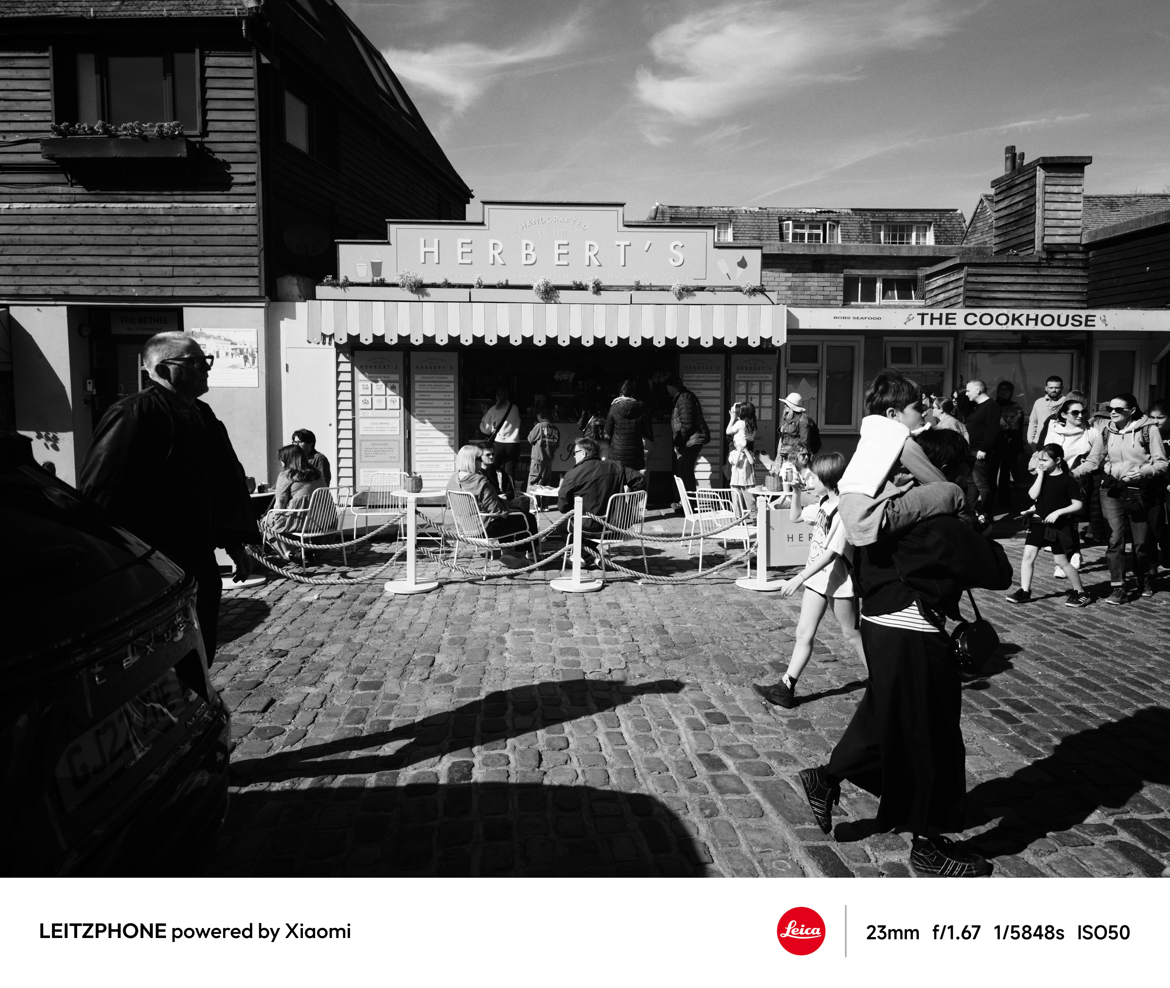 Black-and-white street scene outside Herbert&rsquo;s and the Cookhouse