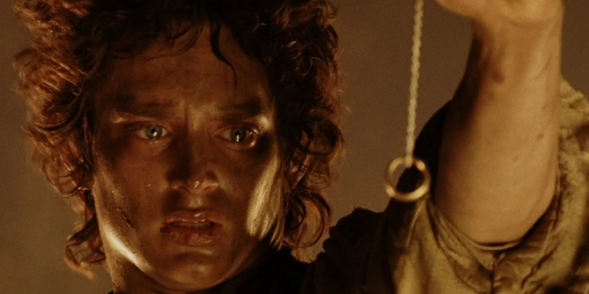 Frodo Baggins (Elijah Wood) holds the One Ring on a long chain in &#039;Lord of the Rings: Return of the King&#039;