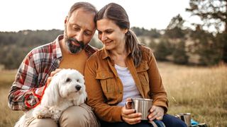 Couple enjoying a picnic, one of many great dog-friendly date ideas