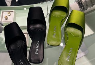 Black and green pairs of Prada square-toe kitten-heel mules.