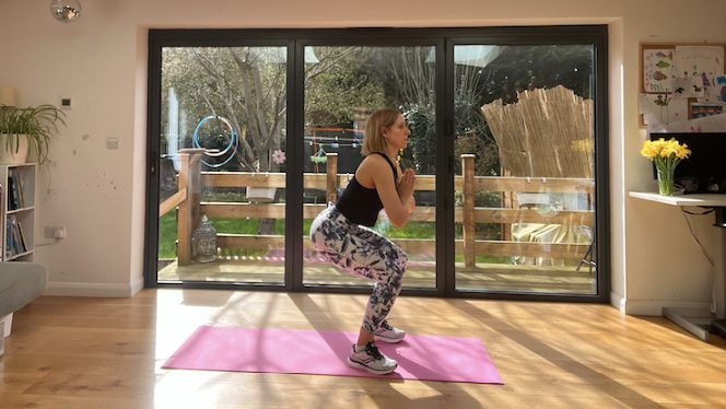 Woman holding a squat