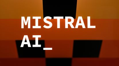 Mistral logo and branding pictured against a multi-colored black, orange, and yellow background.