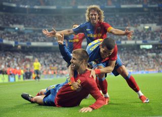 Gerard Pique celebrates with Dani Alves and Carles Puyol after scoring Barcelona's sixth goal against Real Madrid at the Santiago Bernabeu in May 2009.