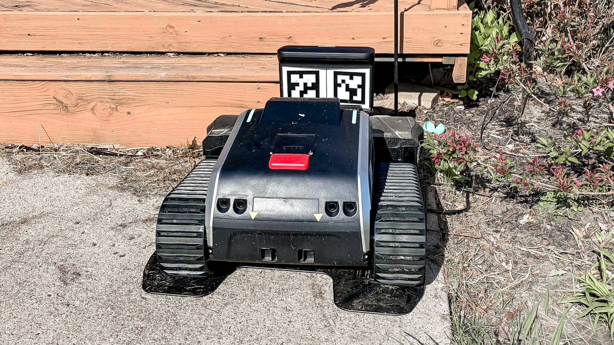 Lymow One Plus robot mower in charging dock
