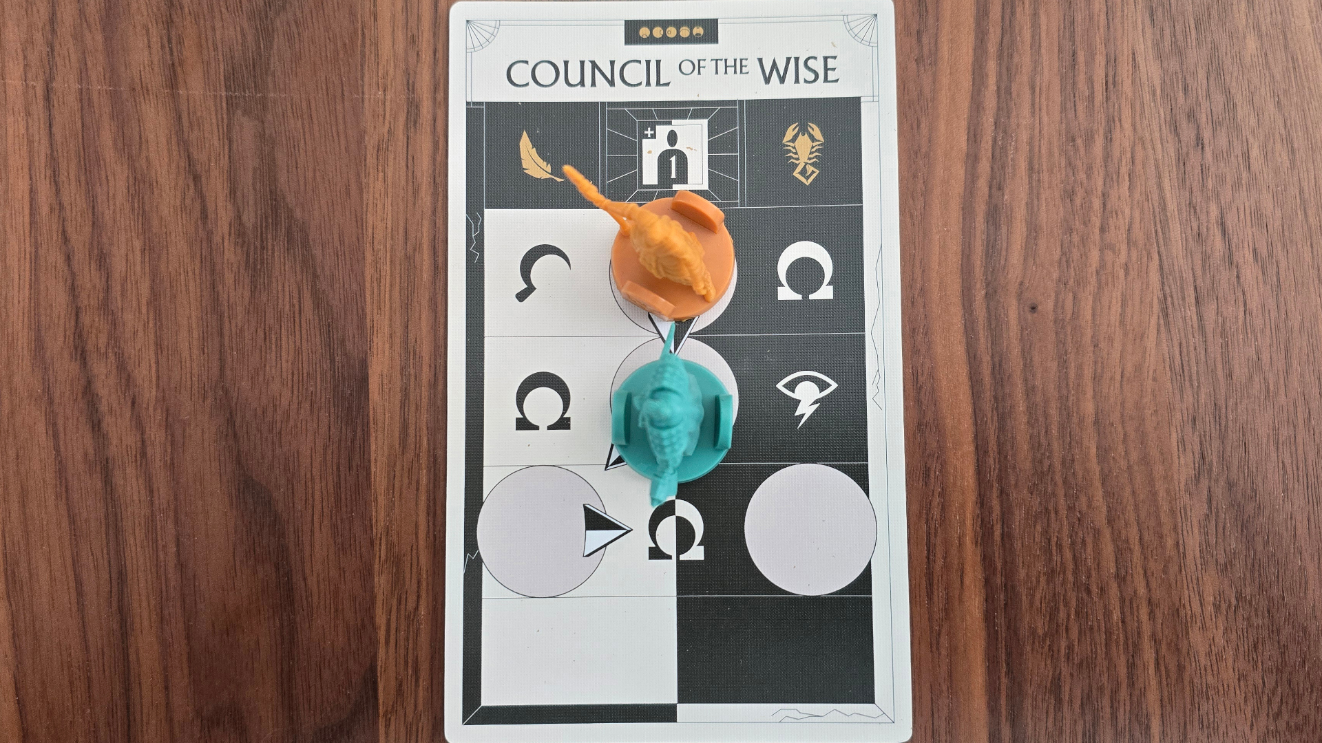 Veiled Fate 'Council of the Wise' card with miniatures on it, all on a wooden surface