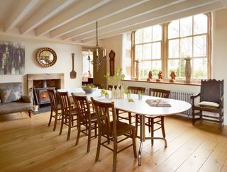 Dining room with large table and chairs and fireplace and wood floor