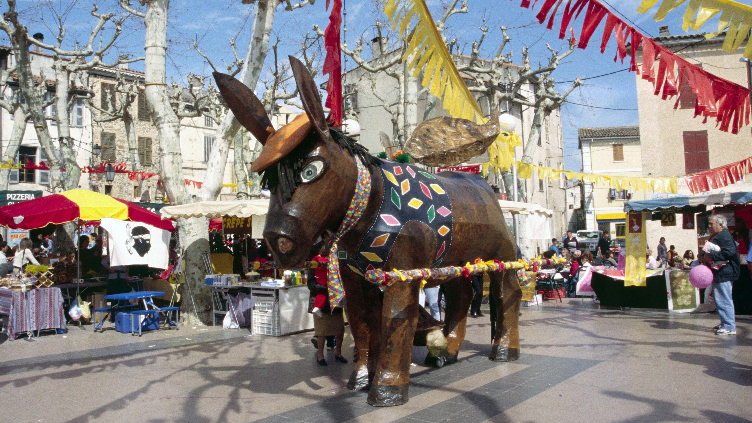 A giant wooden donkey surrounded by paper streamers