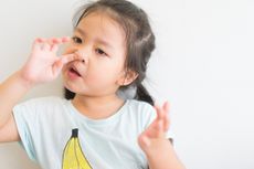 Girl picking her nose.