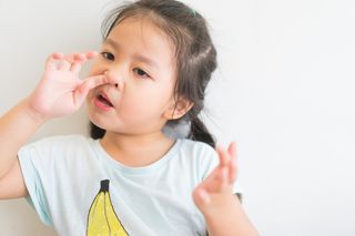 Girl picking her nose.