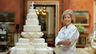 LONDON, ENGLAND - APRIL 29: Fiona Cairns stands next to the Royal Wedding cake that she and her team at Fiona Cairns Ltd of Leicestershire made for Prince William and Catherine Middleton in the Picture Gallery of Buckingham Palace on April 29, 2011 in central London, England. The marriage of Prince William, the second in line to the British throne, to Catherine Middleton is being held in London today. The Archbishop of Canterbury conducted the service which was attended by 1900 guests, including foreign Royal family members and heads of state. Thousands of well-wishers from around the world have also flocked to London to witness the spectacle and pageantry of the Royal Wedding and street parties are being held throughout the UK. (John Stillwell-WPA Pool/Getty Images)