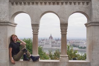 Image shows Anna wearing the Cafe du Cycliste gravel jersey and Crankbrothers Stamp Lace shoes at the Fisherman's Bastion in Budapest.