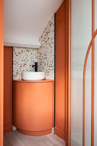 white bathroom with orange cement